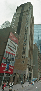 A tall building with a large vertical banner featuring 'NYRX' and images.