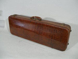 A brown crocodile leather rectangular handbag.